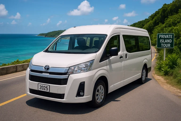 A professional image of a 2025 white Toyota Hiace van on scenic Jamaican north coast road during private island tour